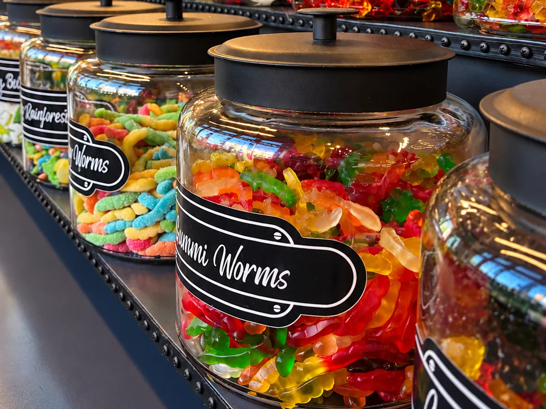 Jars of gummy candy lined up at Nibblers